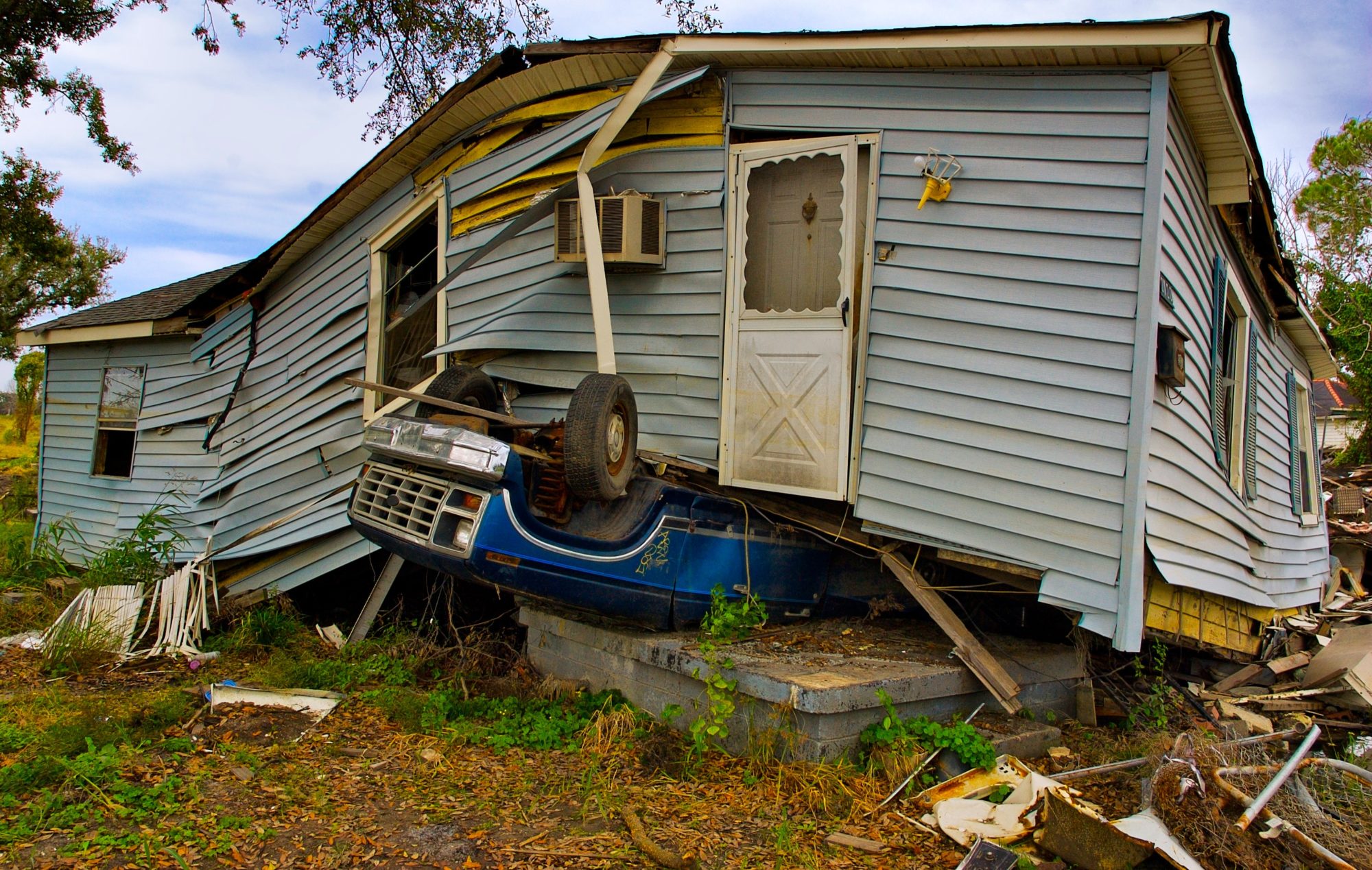 Destroyed house and truck after a hurricane