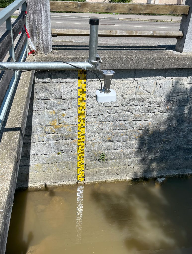 radar level sensor above a channel with a staff gauge